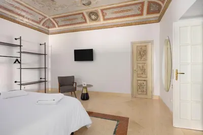 a bedroom with a bed and a tv on the ceiling at Verosicily Sant'Elia suite in Palermo