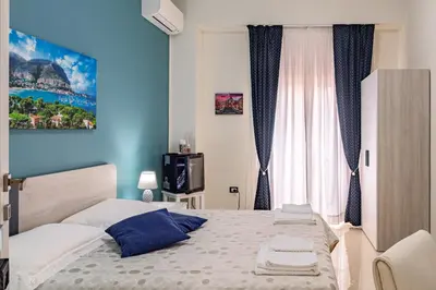 a bedroom with a bed and a tv in it at Sicily Trinacria House in Palermo