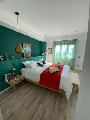 a bedroom with a large bed and green walls at Dimora D'aumale in Palermo