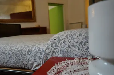 a close up of a bed with a book at Casa Professa Luxury Palermo Center in Palermo