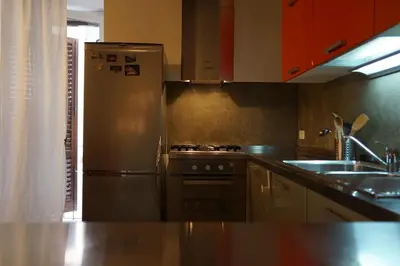 a kitchen with a stainless steel refrigerator and a sink at Casa Professa Luxury Palermo Center in Palermo