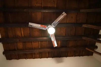 a ceiling fan hanging from a wooden ceiling at Casa Professa Luxury Palermo Center in Palermo