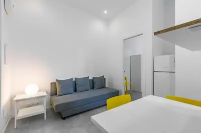 a living room with a couch and a table at GuestHost - Ballarò Market Cozy Apartments in Palermo