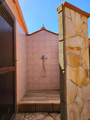 a bathroom with a shower in a brick wall at Costa Mediterranea Holiday Homes in Campofelice di Roccella