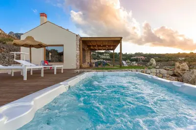 a swimming pool in the backyard of a house at Villa Corallo Cala Bianca in Castellammare del Golfo