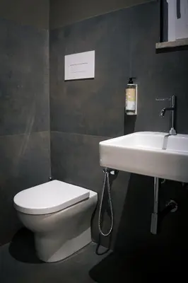 a bathroom with a toilet and a sink at Hostelò - Luxury Hostel in Palermo