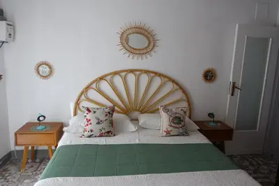 a bedroom with a large bed with pillows and a mirror at Casa Vacanze Flavia in Palermo