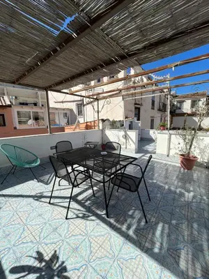 a patio with a table and chairs on a roof at Casa Vacanze Flavia in Palermo
