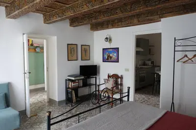 a bedroom with a bed and a living room at Casa Vacanze Flavia in Palermo