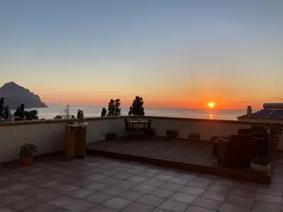 a balcony with a view of the ocean at sunset at Kalura B&B in Macari