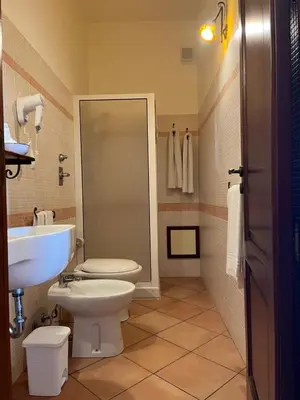 a bathroom with a toilet and a sink at Kalura B&B in Macari