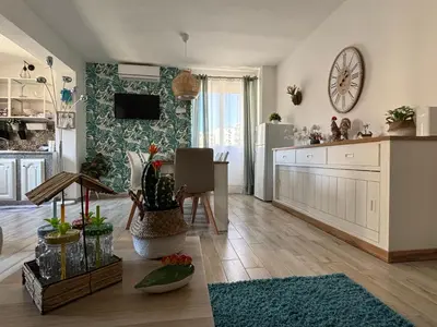 a living room with a kitchen and a dining room at Relais Rosa Apartment in Palermo