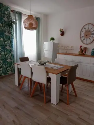 a kitchen with a dining room table and chairs at Relais Rosa Apartment in Palermo