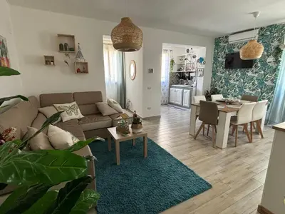 a living room with a couch and a table at Relais Rosa Apartment in Palermo