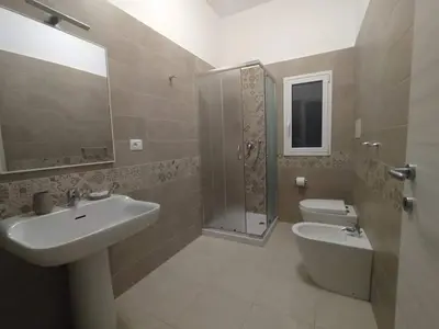 a bathroom with a sink and a shower and a toilet at La Rondine Bed in Ficarazzi