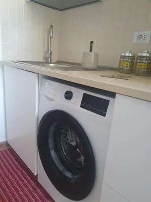a washing machine under a counter in a kitchen at La Casetta del piano di sopra in Palermo