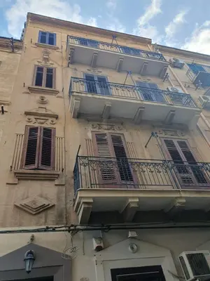a tall building with balconies on the side of it at La Casetta del piano di sopra in Palermo