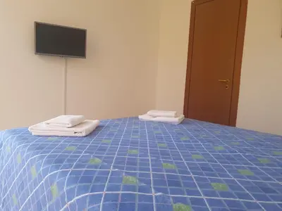 a bedroom with a blue bed with towels on it at La Casetta del piano di sopra in Palermo