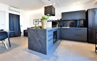 a kitchen with a island in the middle of a room at 2 Bedroom Awesome Apartment In Trappeto in Trappeto