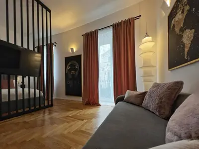 a living room with a couch and a large window at Giglio luxury apartment in casa professa in Palermo
