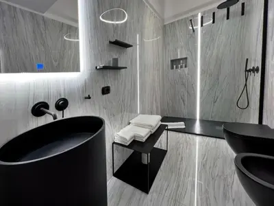 a bathroom with a black sink and a mirror at Giglio luxury apartment in casa professa in Palermo