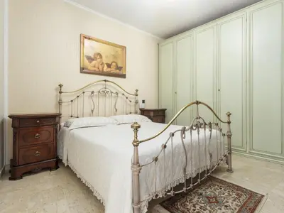 a bedroom with a bed and a painting on the wall at Holiday Home Perla by Interhome in Partinico