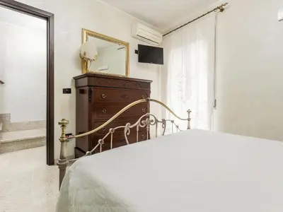 a bedroom with a bed and a dresser and a mirror at Holiday Home Perla by Interhome in Partinico