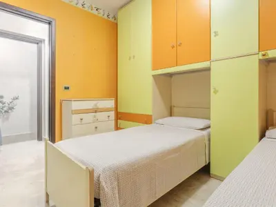 two beds in a room with yellow and orange walls at Holiday Home Perla by Interhome in Partinico
