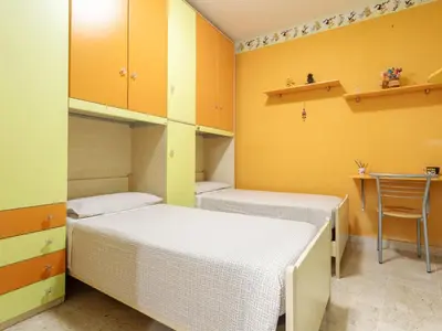 a room with two beds and a table and shelves at Holiday Home Perla by Interhome in Partinico