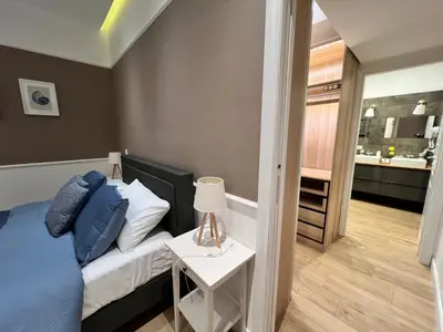 a bedroom with a bed and a small table with a lamp at Florio House in Palermo