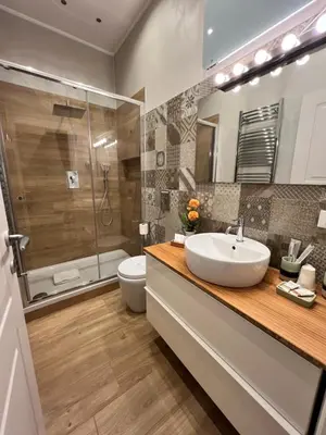 a bathroom with a sink and a toilet and a shower at Florio House in Palermo