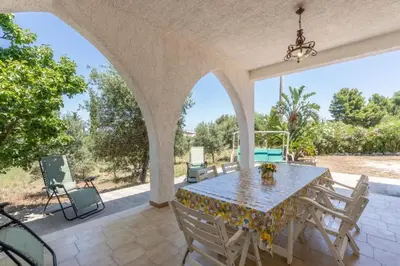 an outdoor patio with a table and chairs at Casa gli Oleandri in Castellammare del Golfo