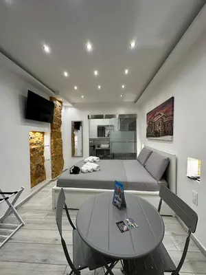 a bedroom with a bed and a table and a couch at Ó sole mio in Palermo