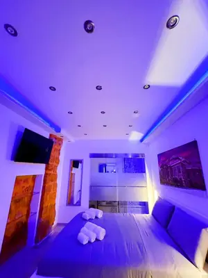 a bedroom with a large bed with purple lighting at Ó sole mio in Palermo