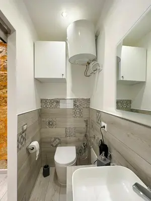 a bathroom with a white toilet and a sink at Ó sole mio in Palermo