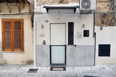 a building with a sign on the side of it at Ó sole mio in Palermo