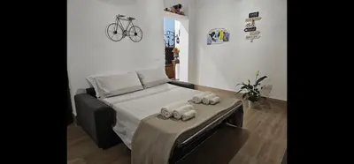 a bedroom with a bed with towels on a table at Appartamento Vista Stazione in Palermo