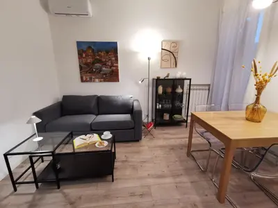 a living room with a couch and a table at Casarino House Luxury Apartment in Palermo