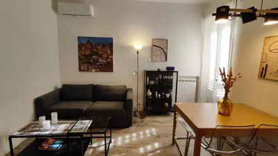 a living room with a couch and a table at Casarino House Luxury Apartment in Palermo