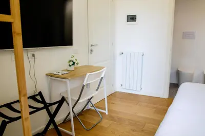 a small table with a chair in a room at Valverde Home in Palermo