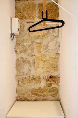 a brick wall with a hanger on a wall at Valverde Home in Palermo