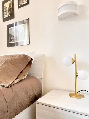 a bedroom with a bed and a table with a lamp at Aristocasa luxury rooms in Palermo