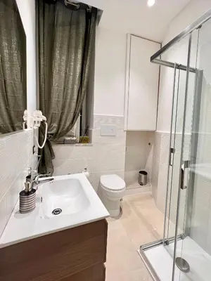 a bathroom with a sink and a toilet and a shower at Aristocasa luxury rooms in Palermo