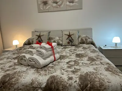 a bedroom with a bed with towels on it at Ciccio's House in Palermo