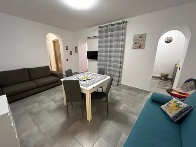 a living room with a table and a couch at Ciccio's House in Palermo