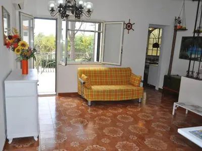 a living room with a couch and a window at CASE VACANZA PERLA DEL SUD in San Vito lo Capo