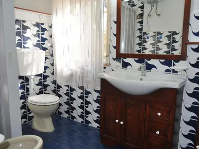 a bathroom with a sink and a toilet at CASE VACANZA PERLA DEL SUD in San Vito lo Capo