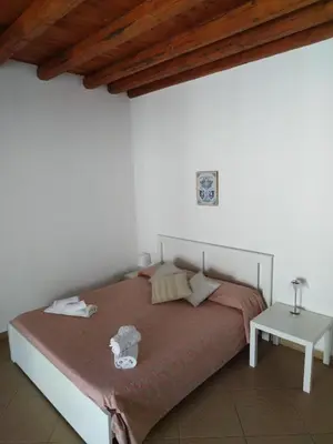 a bedroom with a bed and a wooden ceiling at Dome Suite La Cupoletta in Palermo