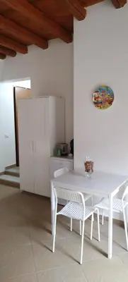 a white table and chairs in a white kitchen at Dome Suite La Cupoletta in Palermo