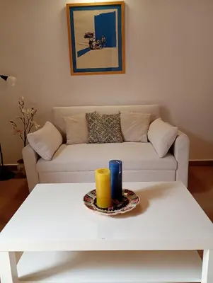 a living room with a white couch and a table at Dome Suite La Cupoletta in Palermo